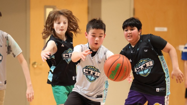 Coach with young kids in basketball jersey