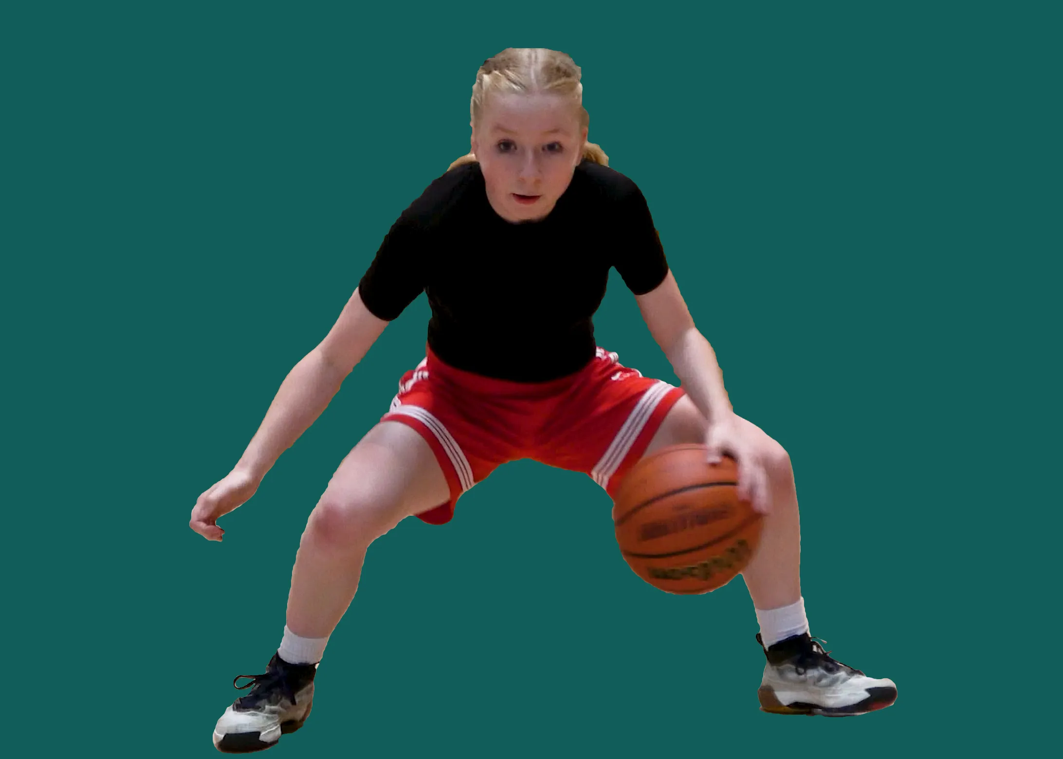 A picture of a CTB basketball player doing a ballhandling drill